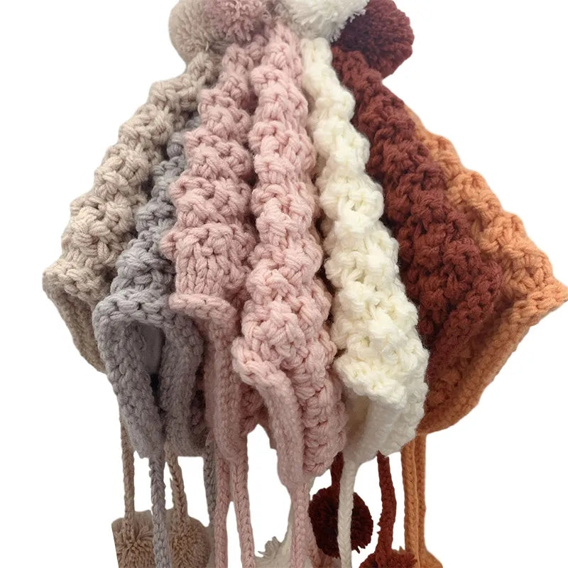 Crochet pixie hat with poms