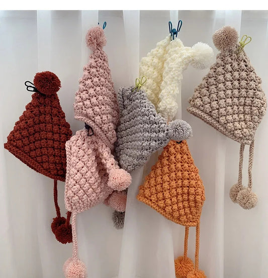 Crochet pixie hat with poms