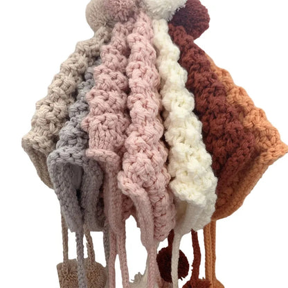 Crochet pixie hat with poms