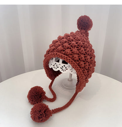 Crochet pixie hat with poms