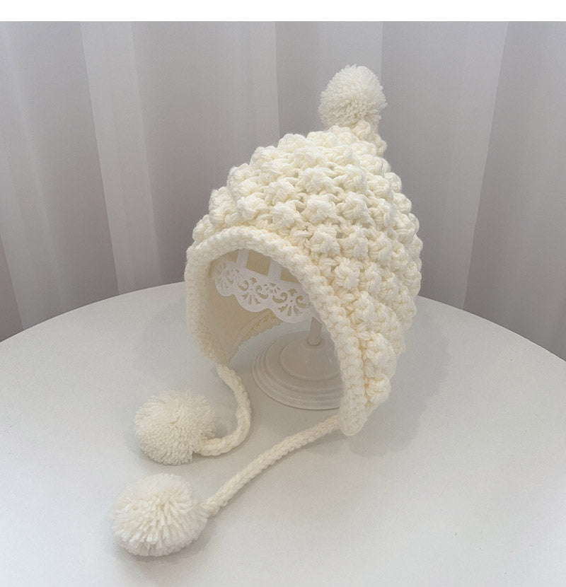 Crochet pixie hat with poms
