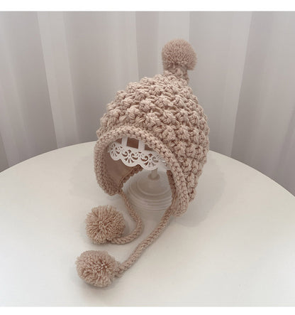 Crochet pixie hat with poms