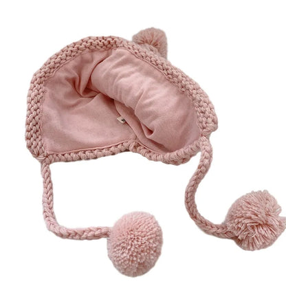 Crochet pixie hat with poms